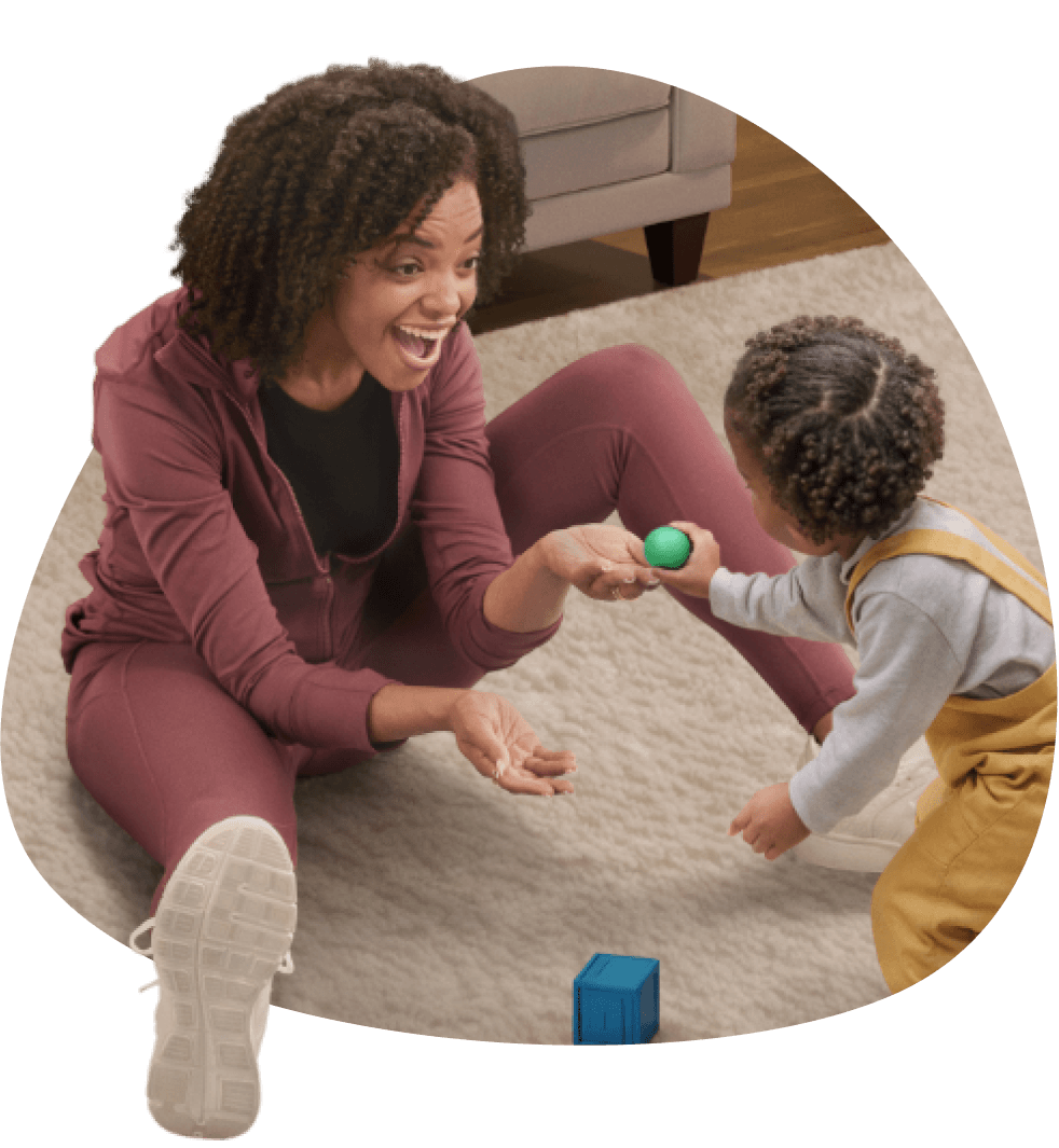 A mother and her toddler playing with toys