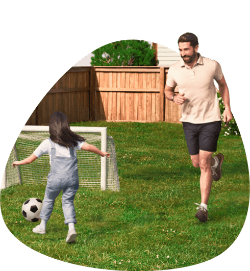 A father playing soccer with his daughter